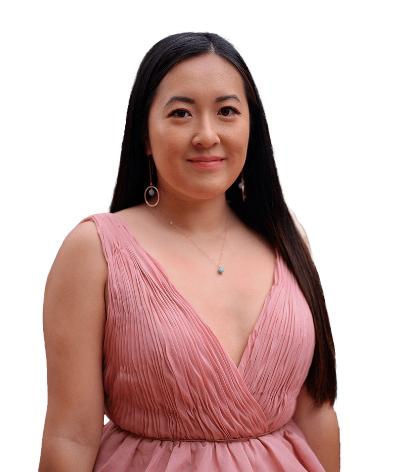 Asian woman wears a pink dress and matching jade earrings and necklace, hair down